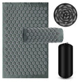 Gray acupressure mat with a close-up inset and a black carrying bag on a white background