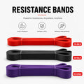 Three resistance bands in red, black, and purple with text indicating weight ranges on a white background.