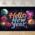 A festive New Year backdrop featuring the words 'Hello New Year' in large, glowing gradient letters over a dark background with colorful fireworks, balloons, and roses. The backdrop is shown hanging in a room mockup with pendant lights above and a wooden floor below.