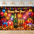 A festive New Year party backdrop featuring a black background with colorful fireworks, balloons, gift boxes, champagne bottles, and two champagne flutes. The words 'Happy New Year' appear in glowing gold text across the center, with hanging bunting and ceiling lights above.