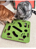 Two cats interacting with a green cat toy on a beige carpet.