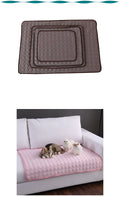 Quilted pet pad in brown on a white background, with two cats on a pink quilted pad on a bed.