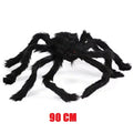 Large black spider toy with red eyes on a white background, labeled '90 CM'.