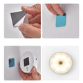 Step-by-step process of using a small electronic device with adhesive pads on a white background.