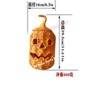 A jack-o'-lantern shaped decorative basket or lantern in a woven straw-like material, shown with dimension lines and text indicating diameter 16 cm / 6.3 in, height 29.