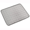 Gray bath mat with textured surface on a white background