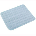 A light blue quilted cooling pad with a circular bubble pattern and rounded corners, shown on a plain white background.