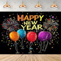A festive New Year party backdrop featuring the text 'HAPPY NEW YEAR' in large gold and orange letters above four colorful balloons (orange, blue, red, purple) on a black background with fireworks and star confetti. The backdrop is shown hanging in a room mockup with a light gray wall, hanging copper pendant lights, and a light wood floor.