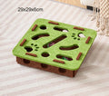 Green and brown pet puzzle toy on a striped surface
