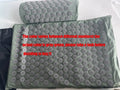 Gray-green pillow with pattern on a white background