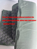 Green fabric cover with textured pattern on a white background