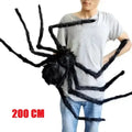 Large black spider prop held by a person, with a measurement label '200 CM'.