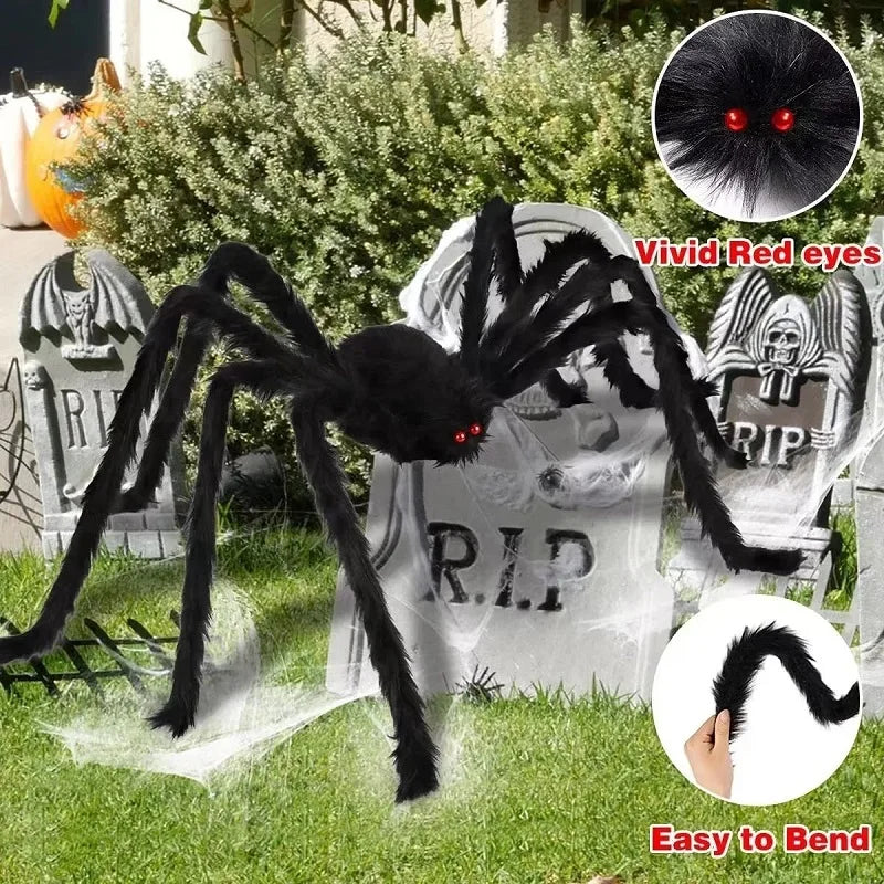 Halloween spider decoration with red eyes and bendable legs in front of tombstones.