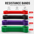 Four resistance bands in red, black, purple, and green with weight indicators on a white background.