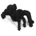 Black spider plush toy on a white background