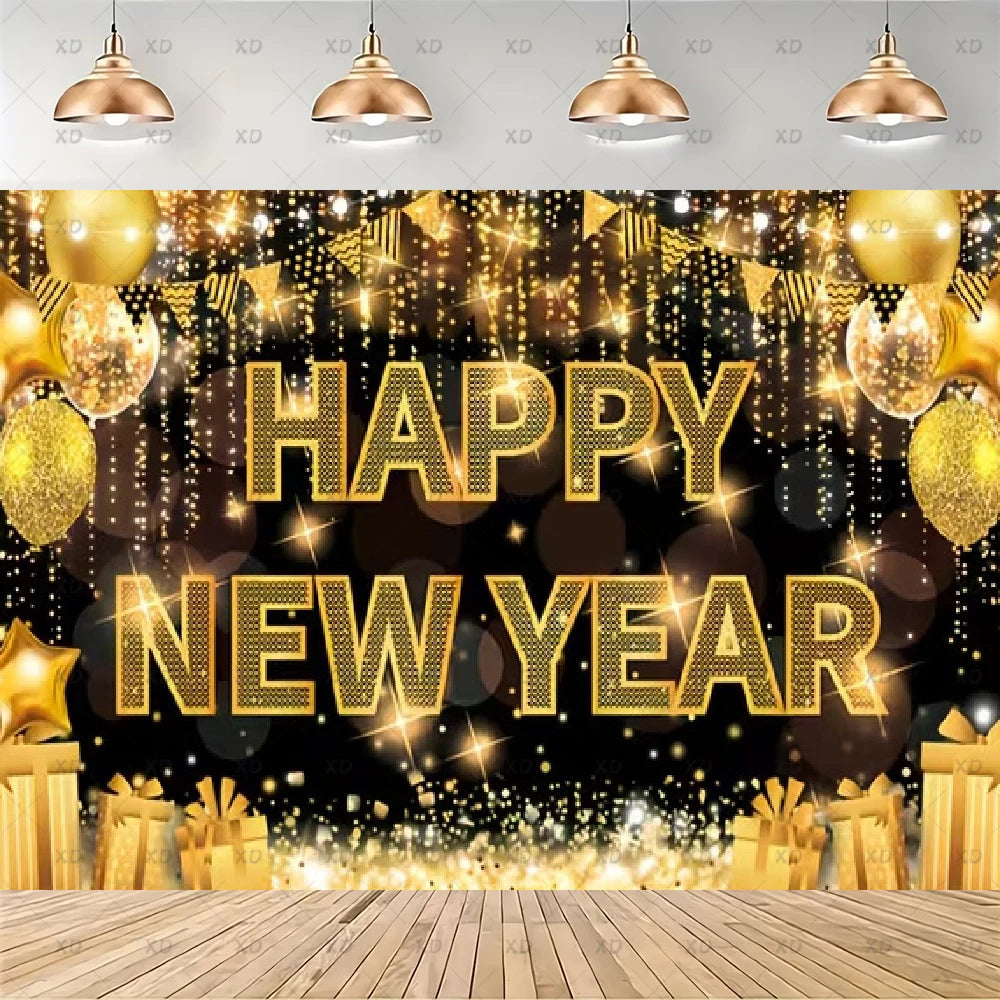 A festive New Year party backdrop featuring 'HAPPY NEW YEAR' in large gold glitter letters, surrounded by hanging gold balloons, falling gold lights, bunting, gift boxes, and a wooden floor. A gray ceiling with hanging copper-colored pendant lights is visible at the top.