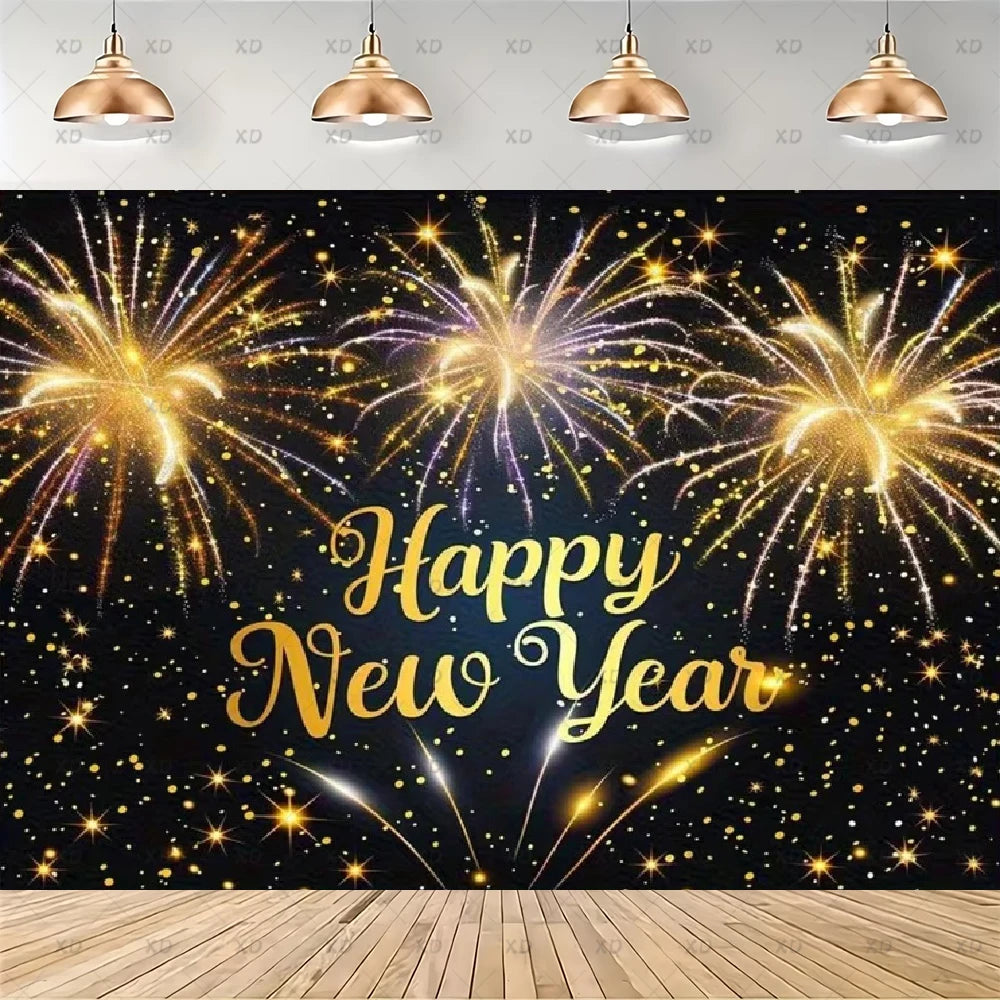A New Year's Eve party backdrop featuring a black background filled with golden and purple fireworks, with 'Happy New Year' written in elegant gold script. The backdrop is shown hanging in a room mockup with four hanging pendant lights above and a wooden floor below.