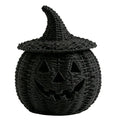 Black woven pumpkin lantern with a pointed witch hat lid, shown on a plain white background.