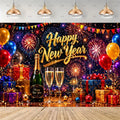 A festive New Year party backdrop featuring a dark blue fireworks background with the words 'Happy New Year' in large gold script. In front are two champagne flutes, a green champagne bottle, and multiple wrapped gift boxes in red, gold, and purple, with colorful balloons and hanging pendant lights above.